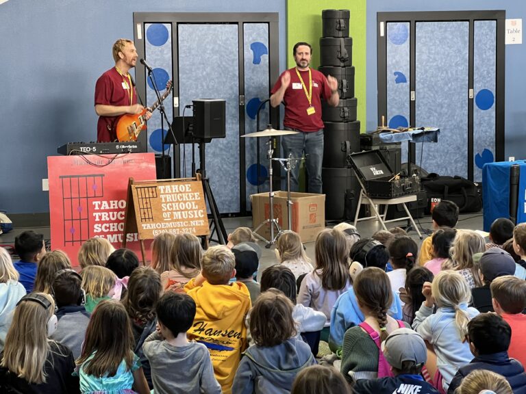 Tahoe Truckee School of Music teachers playing instruments in front of a large group of young students